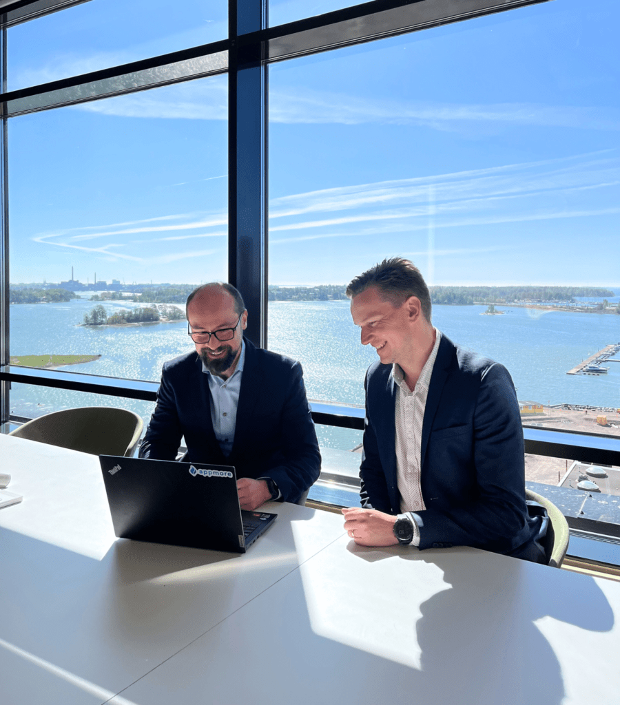 Two men watching a laptop